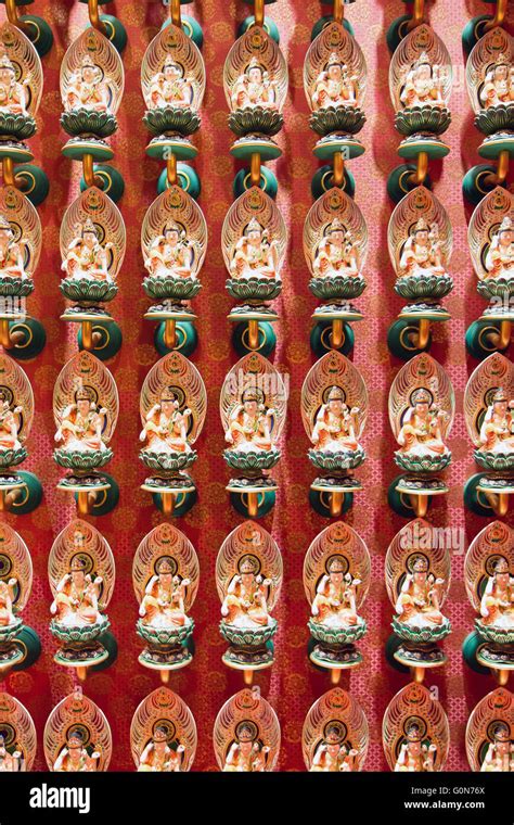 a series of small Buddha statues on the wall, Buddha Tooth Relic Temple in China Town, Singapore ...