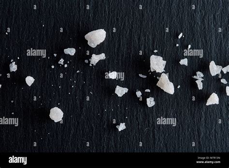 Pile of salt crystals isolated over the dark background, close-up,top ...