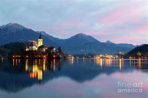 Cozy sunrise on Lake Bled against the backdrop of the castle in Photograph by Roland Barat ...