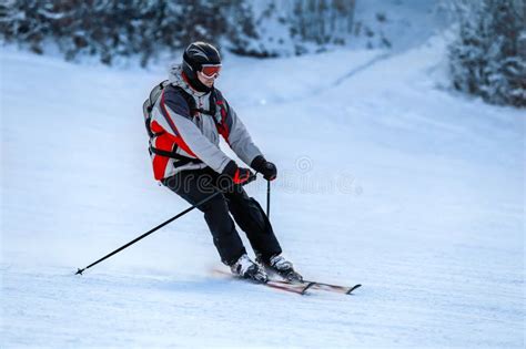 Skier in Ski Suit Slides Down from Snow Slope Stock Image - Image of ...