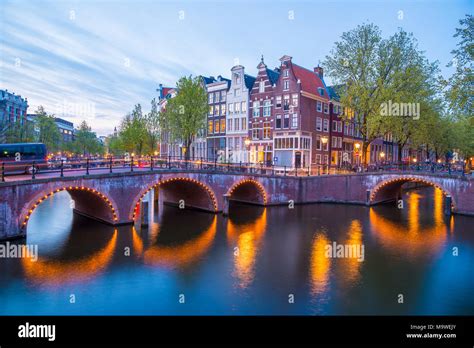 Famous Amstel river and night view of beautiful Amsterdam city ...