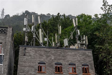 5G antenna base station on top of residence building in the mountain in ...