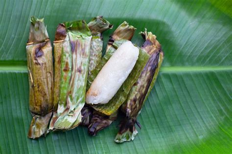 Premium Photo | Grilled sticky rice in banana leaves with banana filling