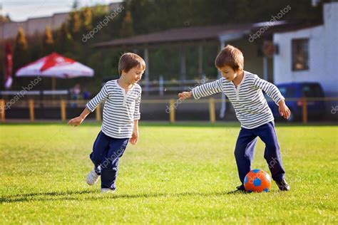 Two cute little boys, playing football — Stock Photo © t.tomsickova ...