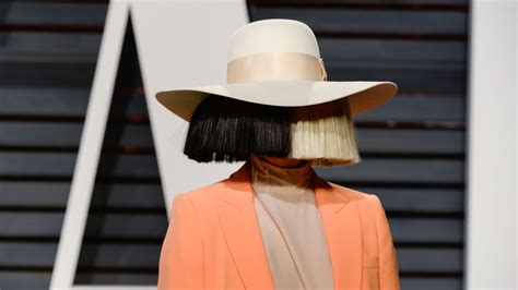 Sia Makes Rare Public Appearance With Face Uncovered: Photos | Allure