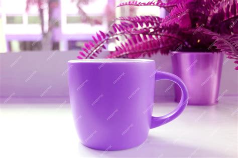 Premium Photo | Pop art style vivid purple colored coffee mug with potted ferns on a table