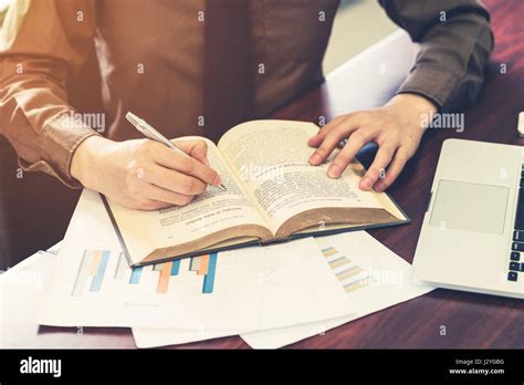 Young business man writing book in the office with sunlight. Vintage toned filter Stock Photo ...