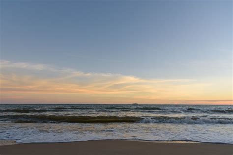 Premium Photo | Evening view of a beach with some sea waves