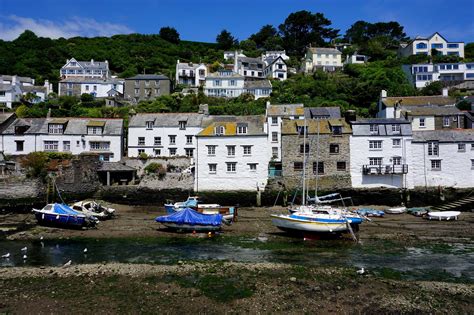 Polperro village, England, another view of the quaint harbor at low tide showing the wonderful ...