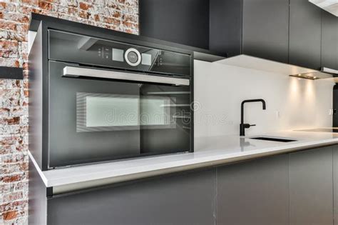 A Black and White Kitchen with a Black Microwave Oven Stock Image ...