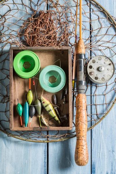 Fly fishing equipment with hat on wooden dock — Stock Photo © Sandralise #12020941