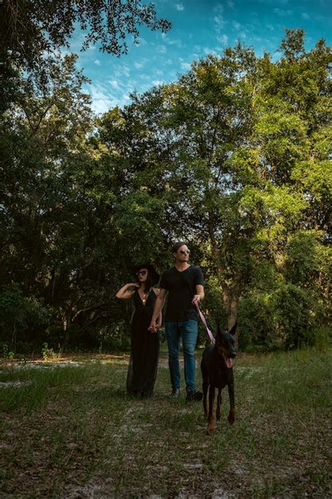 Couple Walking Their Pet Dog · Free Stock Photo