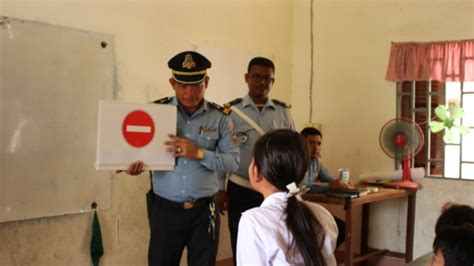 Manulife volunteers and local police engage with Kampong Cham community on road safety concepts ...