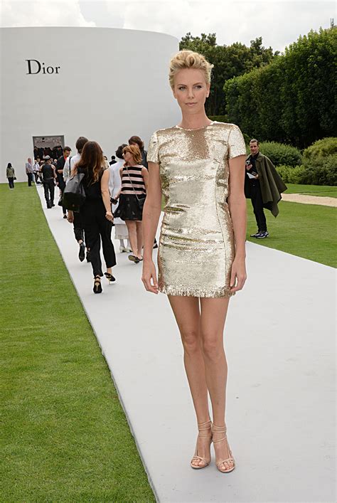 Charlize let her gold mini-sheath dress speak for itself at the Dior | Celebrate Charlize Theron ...