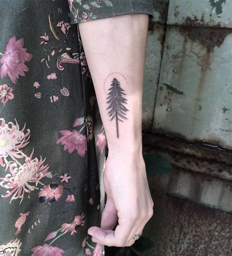 Small fir tree tattoo on the right forearm - Tattoogrid.net