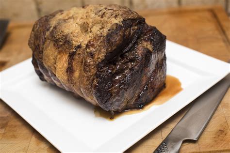 Seasoned whole roast joint of beef served on plate-9890 | Stockarch Free Stock Photo Archive