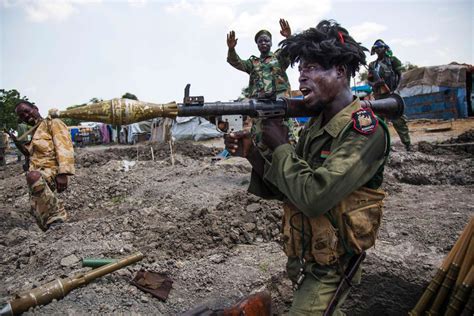 Soldiers of the Sudan People’s Liberation Army (SPLA) celebrate while standing in trenches in ...