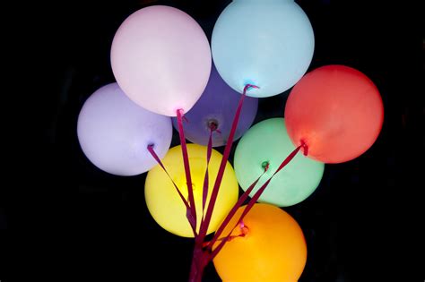 Free Image of Colorful Balloons on Laces Isolated on Black | Freebie.Photography