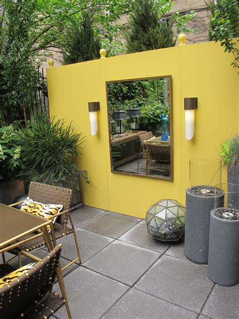 Yellow wall at Elle Decor Modern Life Concept House | Garden wall decor, Patio wall art, Patio wall