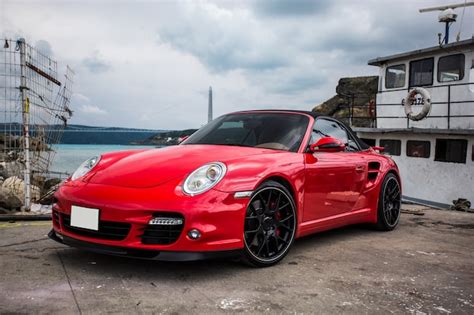 Free Photo | A red mini coupe parked in the port.