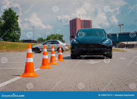 Modern Car and Safety Cones in Driving School Outdoors. Young Female ...