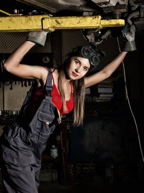 Beautiful Young Female Mechanic Inspecting Car in Auto Repair Shop ...