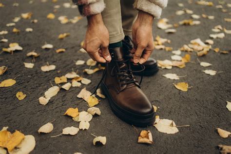 Close-Up Shot of a Person Tying Shoelaces · Free Stock Photo