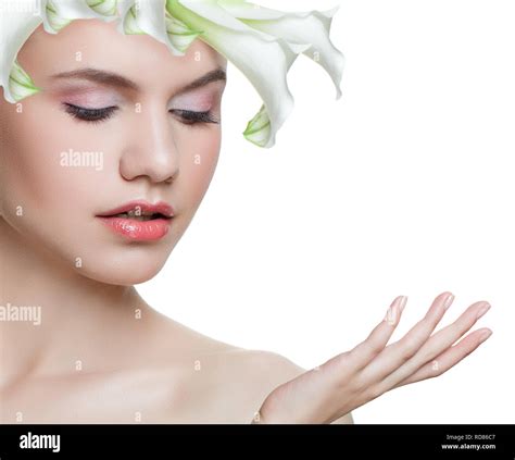 Spa beauty. Young woman with white flower isolated on white background. Beautiful face. Facial ...