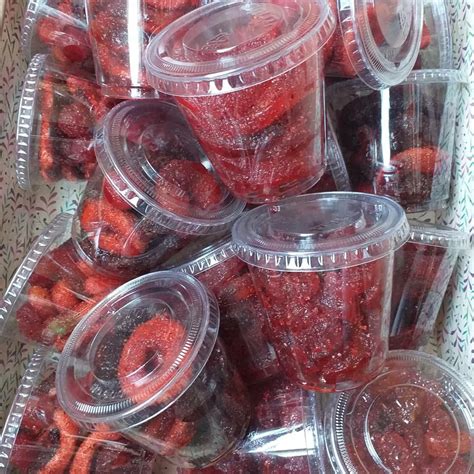 several plastic containers filled with red candies