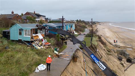 Shocking moment seaside homes are reduced to rubble after storms ...