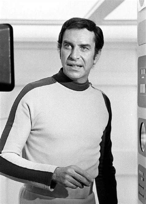 black and white photo of man in star trek uniform standing next to ...