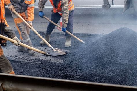 Premium Photo | A working group of road workers renews part of the road