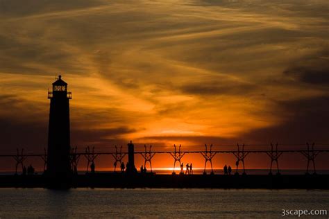 Sunset at Grand Haven pier and lighthouse Photograph by Adam Romanowicz