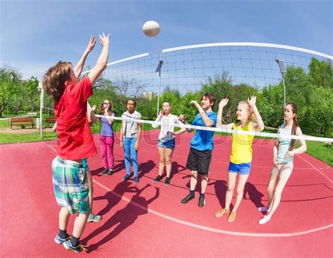 Active boy and girls playing volleyball ... | Stock image | Colourbox