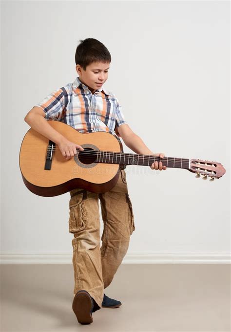 Boy is Playing the Acoustic Guitar on White Background Stock Image ...