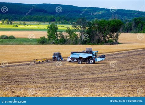 A Modern Blue Combine Harvester Stands on a Field Where the Spring ...