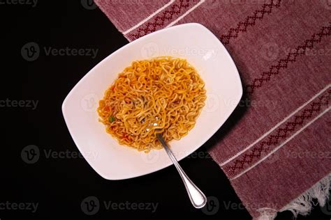 Instant like maruchan soup in white plate on black background 16276084 Stock Photo at Vecteezy