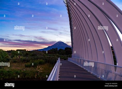 Mt Taranaki behind Te Rewa Rewa bridge at beautiful purple sunset Stock Photo - Alamy