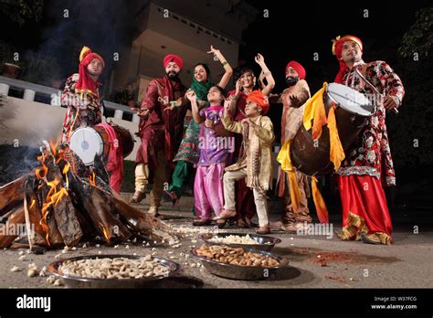 Family celebrating Lohri festival, Punjab, India Stock Photo - Alamy