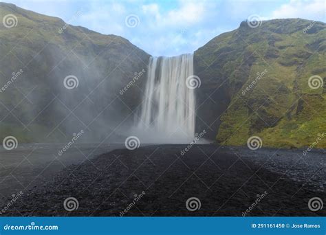 Woman at the Base of Skógafoss Stock Photo - Image of spray, claim ...