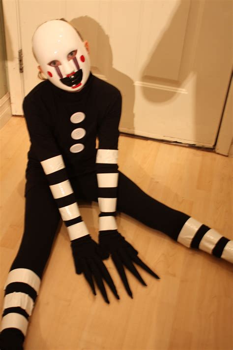 a person in a creepy costume sitting on the floor