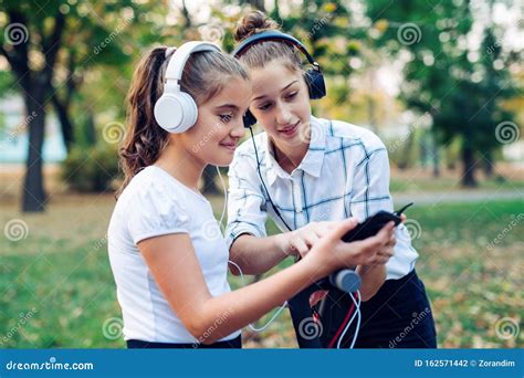 Two Happy Friends Listening To Music by Smart Phone. Stock Photo - Image of beautiful, cell ...