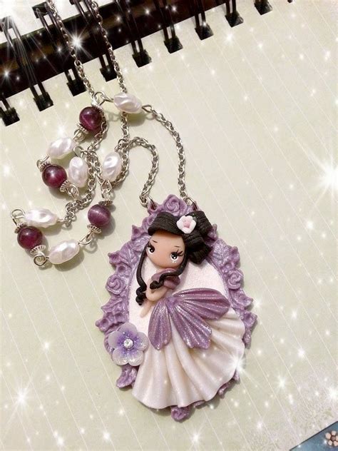 a purple and white necklace with an image of a woman on it, surrounded by pearls