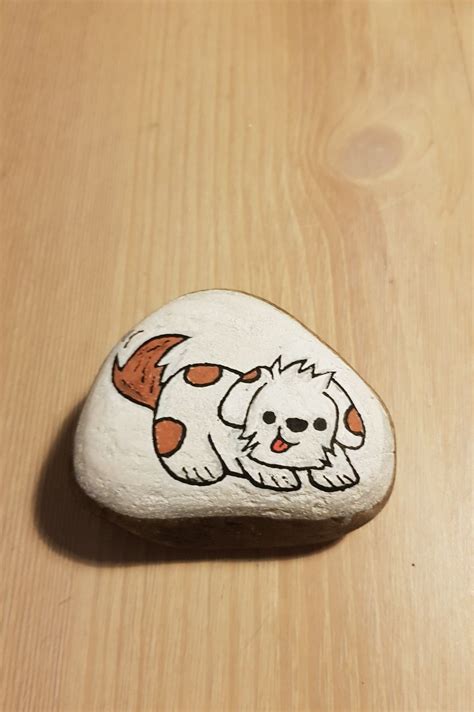 a rock with a dog painted on it