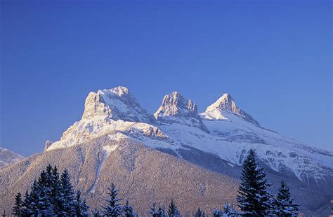 Three Sisters Mountains, Canmore by John E Marriott