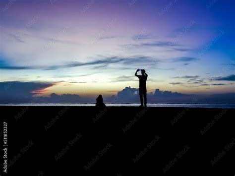 Sunrise silhouette couple taking pictures Stock Photo | Adobe Stock