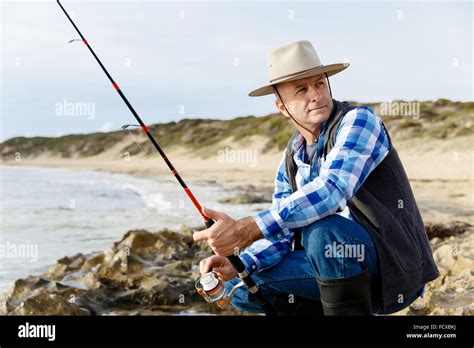 Picture of fisherman fishing with rods Stock Photo - Alamy