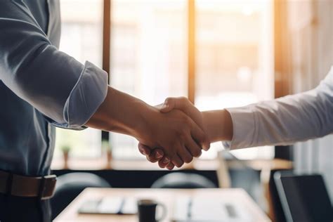 Premium Photo | Two businessmen shaking hands in an office Deal has ...