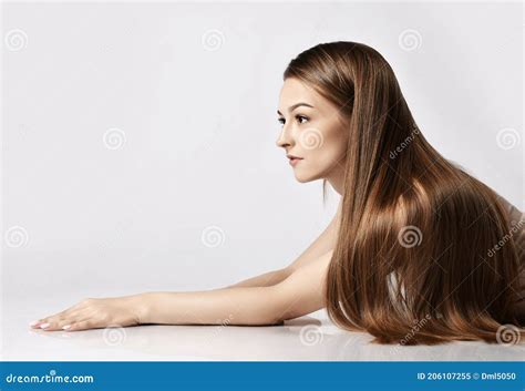 Profile of Young Woman Lying on Elbows with Her Long Silky Hair Falling Over Her Shoulder and ...