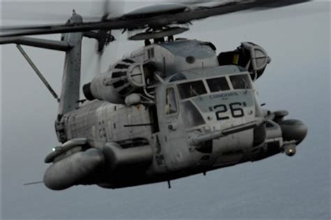 A U.S. Marine Corps CH-53 Sea Stallion helicopter approaches a HC-130 ...